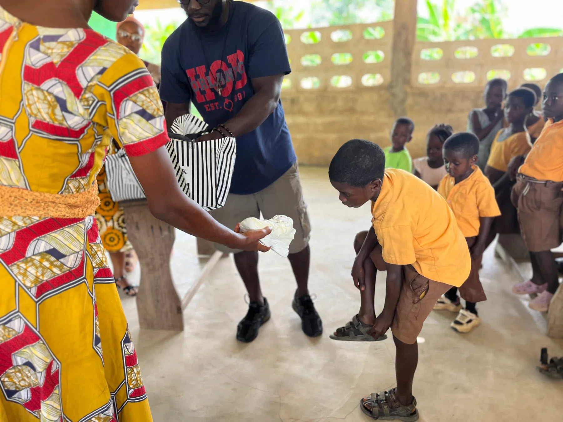 Schoolchildren lined up to receive new shoes